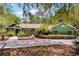 Inviting ranch style home with green exterior, lush landscaping, and a spacious driveway at 2705 Curryville Rd, Chuluota, FL 32766