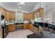 Bright kitchen featuring wooden cabinets, granite countertops, and stainless steel appliances, ideal for cooking and entertaining at 2705 Curryville Rd, Chuluota, FL 32766
