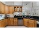 Kitchen with wooden cabinets, stainless steel appliances, and granite countertops, perfect for cooking enthusiasts at 2705 Curryville Rd, Chuluota, FL 32766