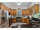Spacious kitchen with stainless appliances, granite countertops, and custom wood cabinets at 2705 Curryville Rd, Chuluota, FL 32766