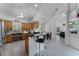 Open kitchen featuring wooden cabinets, black countertops, a breakfast bar, and views into the open floor plan at 2705 Curryville Rd, Chuluota, FL 32766