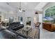 Spacious living room featuring elegant furnishings, a fireplace, and natural light, ideal for gatherings and relaxation at 2705 Curryville Rd, Chuluota, FL 32766