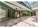 Spacious covered patio with stone flooring and comfortable seating for outdoor enjoyment at 2705 Curryville Rd, Chuluota, FL 32766