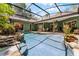 View of the beautiful backyard pool, enclosed in a screen and surrounded by lush landscaping at 2705 Curryville Rd, Chuluota, FL 32766