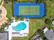 Aerial view of the community tennis court and pool, surrounded by lush landscaping at 2706 Donaldson Dr, Orlando, FL 32812