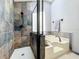 Bathroom features a unique tiled shower with a glass partition and a garden tub at 2706 Donaldson Dr, Orlando, FL 32812