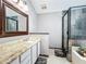Full bathroom featuring a vanity with granite countertop, tiled shower, and a garden tub at 2706 Donaldson Dr, Orlando, FL 32812