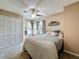 Cozy bedroom featuring a ceiling fan, closet and a large window at 2706 Donaldson Dr, Orlando, FL 32812