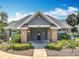 Exterior view of the community clubhouse, featuring well-manicured landscaping at 2706 Donaldson Dr, Orlando, FL 32812