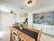 Open-concept dining area with a large table, decorative buffet, and connecting kitchen at 2706 Donaldson Dr, Orlando, FL 32812