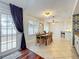 Bright dining room features a wood table, tile floors, and sliding glass door access to outdoor living spaces at 2706 Donaldson Dr, Orlando, FL 32812