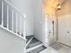 Entryway featuring staircase, a decorative rug, and a front door with glass sidelights and a peephole at 2706 Donaldson Dr, Orlando, FL 32812