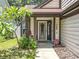 Inviting front entrance with a decorative door, manicured landscaping, and exterior lighting at 2706 Donaldson Dr, Orlando, FL 32812