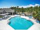 Aerial view of the community pool with clubhouse, seating, and lush landscaping at 2706 Donaldson Dr, Orlando, FL 32812
