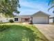 Charming single-story home with well-maintained lawn and landscaping, plus attached two-car garage at 2708 La Posada Dr, The Villages, FL 32162