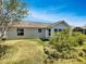 The backyard of this charming single-story home with a well-maintained lawn and gray siding is great for outdoor activities at 2708 La Posada Dr, The Villages, FL 32162