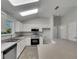 Well-lit kitchen featuring modern appliances, white cabinetry, and ample counter space for cooking at 2708 La Posada Dr, The Villages, FL 32162