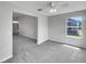 Open-concept living room with neutral tones, plush carpet, and natural light creates a welcoming and airy space at 2708 La Posada Dr, The Villages, FL 32162