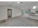 Open-concept living room and kitchen with modern lighting fixture and seamless flow at 2708 La Posada Dr, The Villages, FL 32162