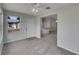 Bright living room with plush carpet and a view of the backyard, creating a cozy and inviting atmosphere at 2708 La Posada Dr, The Villages, FL 32162
