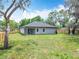 Backyard view features a covered patio and ample green space, ideal for outdoor activities at 278 Acorn Dr, Longwood, FL 32750