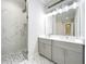 Elegant bathroom featuring marble-tiled shower and double vanity sinks at 278 Acorn Dr, Longwood, FL 32750