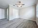 Well-lit bedroom with wood-look floors, closet, and ceiling fan at 278 Acorn Dr, Longwood, FL 32750