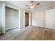 Neutral bedroom with closet, wood-look floors, and ceiling fan at 278 Acorn Dr, Longwood, FL 32750
