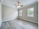 Neutral bedroom with hardwood flooring, ceiling fan, crown molding, and two windows at 278 Acorn Dr, Longwood, FL 32750