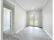 Bright entryway features wood-look floors and decorative glass double doors at 278 Acorn Dr, Longwood, FL 32750