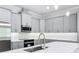Modern kitchen featuring gray cabinets, stainless steel appliances, and white subway tile backsplash at 278 Acorn Dr, Longwood, FL 32750