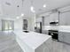 Beautiful kitchen featuring gray cabinets, stainless steel appliances, and a large marble island at 278 Acorn Dr, Longwood, FL 32750