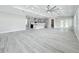 Expansive living area with an open layout, complemented by a kitchen island and wood-look flooring at 278 Acorn Dr, Longwood, FL 32750