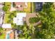 An aerial view of the property showing the house, driveway, and surrounding trees and neighborhood at 2814 Conway Gardens Rd, Orlando, FL 32806