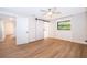 Bright bedroom with modern floors, a barn door and natural light shining in at 2814 Conway Gardens Rd, Orlando, FL 32806