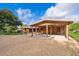 Home exterior featuring gravel driveway, green grass, and ample covered parking at 2814 Conway Gardens Rd, Orlando, FL 32806