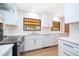 All-white kitchen with bright countertops, modern appliances, and beautiful tilework at 2814 Conway Gardens Rd, Orlando, FL 32806