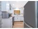 Modern kitchen with stainless steel appliances, white cabinets, and hardwood floors at 2814 Conway Gardens Rd, Orlando, FL 32806