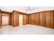 Finished basement living room featuring wood paneling and a barn door to the bathroom at 2814 Conway Gardens Rd, Orlando, FL 32806