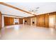 Large living room with wood paneled walls, wooden ceiling beams, and tile floors at 2814 Conway Gardens Rd, Orlando, FL 32806