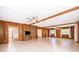 Living room displaying tile floors, wood paneled walls and a view to the kitchen at 2814 Conway Gardens Rd, Orlando, FL 32806