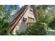 A-frame home with red trim needing some yard work and love at 283 Oak Ln, New Smyrna Beach, FL 32168