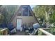 A-frame home featuring a red trim, a large window, and a covered deck at 283 Oak Ln, New Smyrna Beach, FL 32168