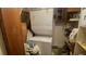 Stackable washer and dryer in a small laundry room with storage shelves at 283 Oak Ln, New Smyrna Beach, FL 32168
