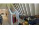 Angled ceilings lead to a cozy living room with a staircase and warm interior at 283 Oak Ln, New Smyrna Beach, FL 32168