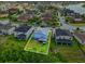 Aerial backyard view of the two-story home with green grass and solar panels at 2926 Boating Blvd, Kissimmee, FL 34746
