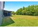 View of the large backyard with a screened in patio on a sunny day at 2926 Boating Blvd, Kissimmee, FL 34746