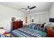 Bedroom with two beds, a wooden dresser, and a ceiling fan for added comfort at 2926 Boating Blvd, Kissimmee, FL 34746