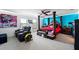 Well-lit bedroom with a four-poster bed, plush seating, and vibrant wall decor at 2926 Boating Blvd, Kissimmee, FL 34746