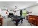 Spacious game room with a pool table, bar area, and ample wall decor at 2926 Boating Blvd, Kissimmee, FL 34746
